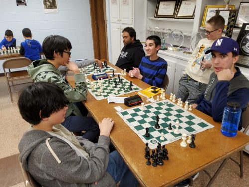 Young team with chess board
